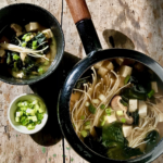Miso Soup with Wakame Seaweed, Tofu, and Mushrooms in a bowl.